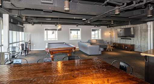 A room with a pool table and a couch.
