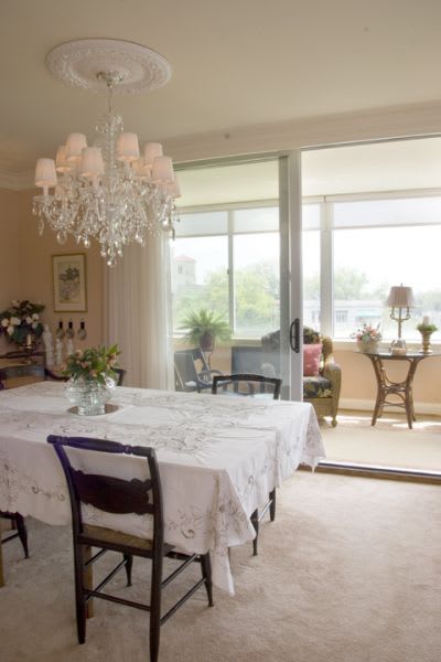 A dining room with a table set for a meal.