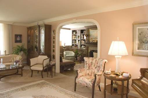 A living room with a chair, a table, and a lamp.