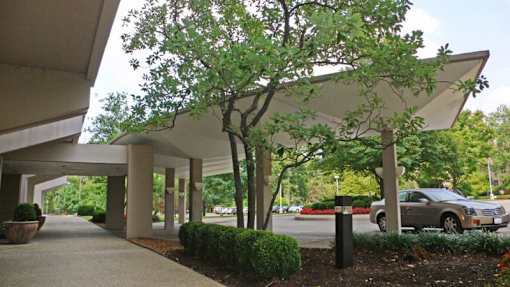 A parking garage with a car parked in the background.