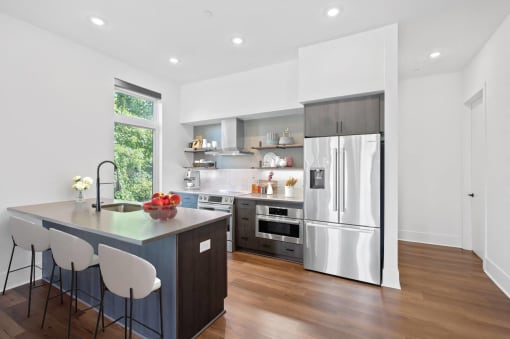 a kitchen with a large island and a stainless steel refrigerator at Four23/Hoge, Ohio