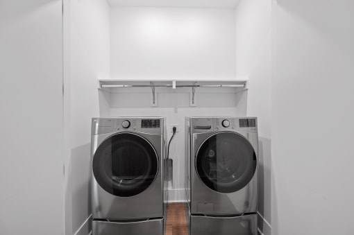 two washing machines in a white laundry room at Four23/Hoge, Ohio