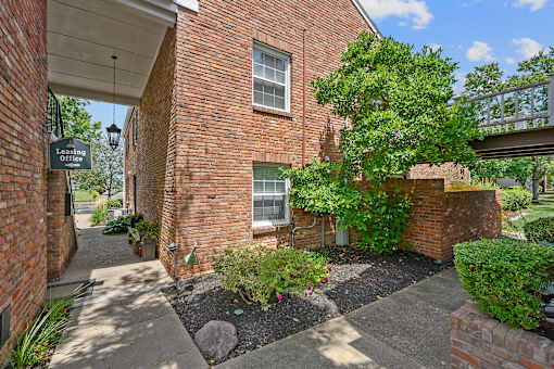 a side view of a brick building with a tree and a sidewalk at Olde Towne in Kenwood, Cincinnati, OH, 45243