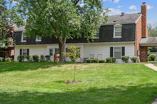 a white house with a tree in the front yard at Olde Towne in Kenwood, Ohio
