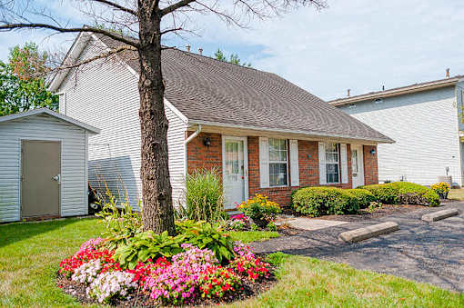 a small white house with a tree in the front yard at Parkside at Maple Canyon Apartments, Columbus, OH