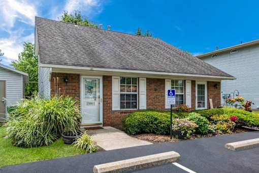 the front of a brick house with a porch and a driveway at Parkside at Maple Canyon Apartments, Columbus, Ohio