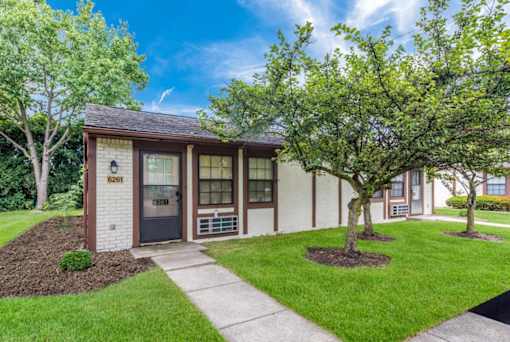 a small building with a sidewalk and trees in front of it at Parkside at Maple Canyon Apartments, Columbus, OH 43229