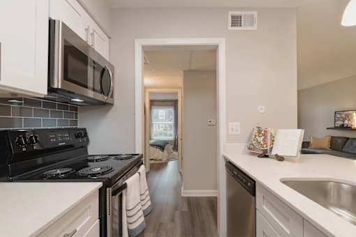 A kitchen with black and white appliances and a white counter at A62 Apartments, Indianapolis, IN 46220