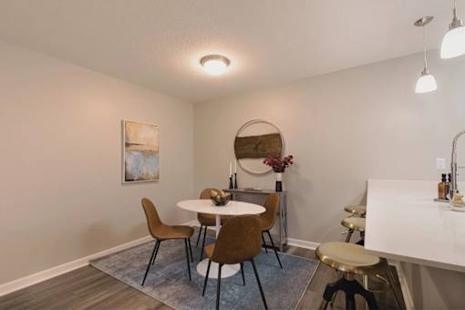 A dining room with a round table and chairs at A62 Apartments, Indianapolis, IN