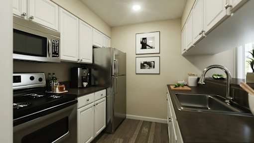 A kitchen with black countertops and white cabinets at A62 Apartments, Indiana 46220