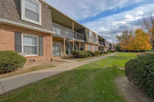 A row of apartment buildings with a sidewalk in front at A62 Apartments, Indianapolis 46220