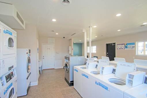 A laundry room with washers and dryers at A62 Apartments, Indianapolis