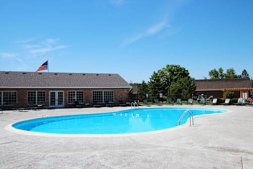 A swimming pool in front of a building with an American flag at A62 Apartments, Indianapolis 46220