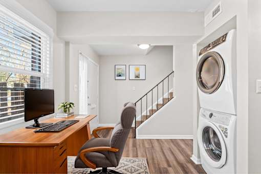 A washing machine is in a laundry room.