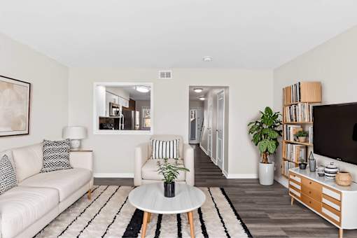 A living room with a white couch and a coffee table.