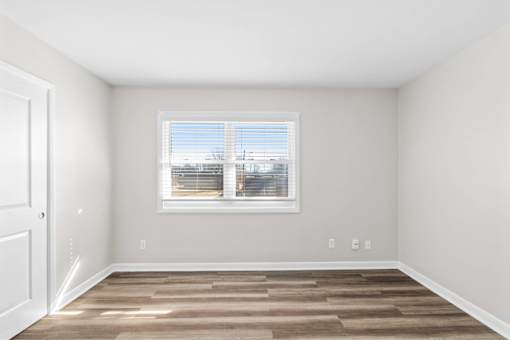 A room with a window and a door.