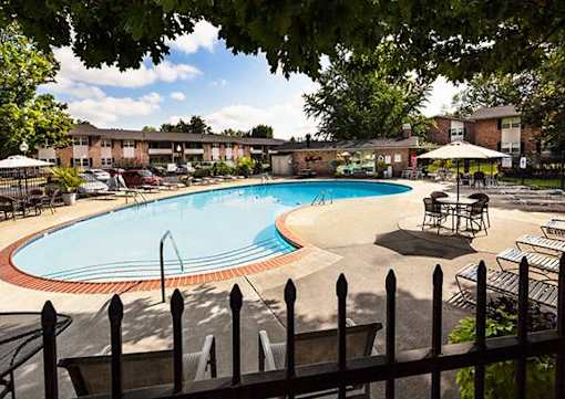 A pool surrounded by a black fence.