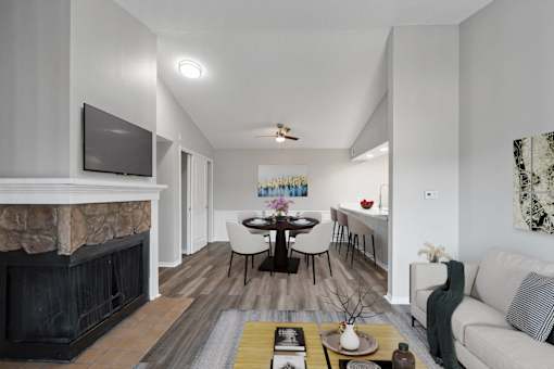A modern living room with a fireplace and a television.at Crooked Creek, Indianapolis Indiana