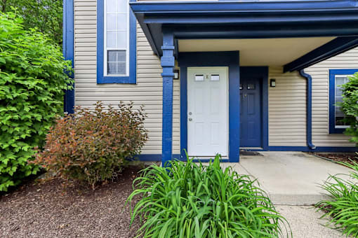 A house with a white door and blue trim.