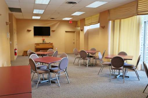 A conference room with a table and chairs.