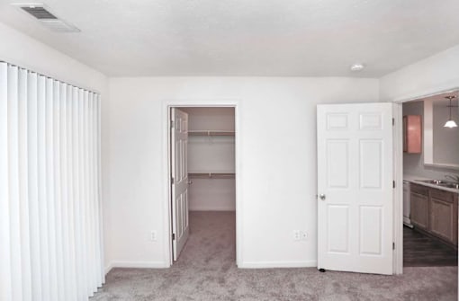 A white room with a doorway leading to another room.