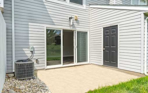 A house with a grey siding and a black door.
