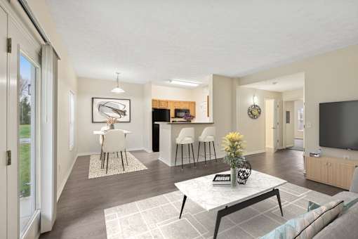 A modern living room with a white coffee table and a television.