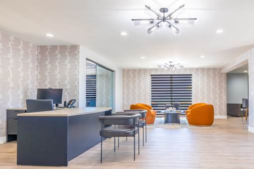 an office with a desk and chairs and a conference room
