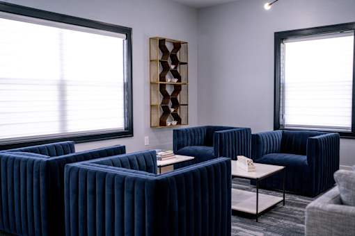 a living room with blue couches and a coffee table at Ten31, Dayton, 45458