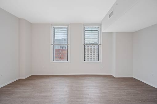 A room with two windows and a wooden floor at Sky Central Apartments, Cincinnati, 45202