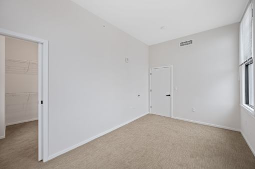 A white room with a door and a window at Sky Central Apartments, Cincinnati