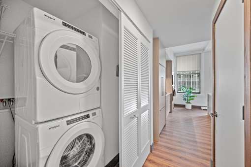A laundry room with a washer and dryer stacked on top of each other at Sky Central Apartments, Ohio, 45202