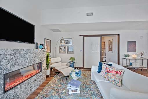 A living room with a fireplace and a couch at Sky Central Apartments, Cincinnati