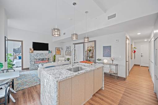 A modern kitchen with a marble island and pendant lights at Sky Central Apartments, Cincinnati, Ohio