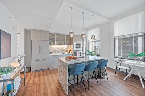 A modern kitchen with a dining table and chairs at Sky Central Apartments, Cincinnati, Ohio