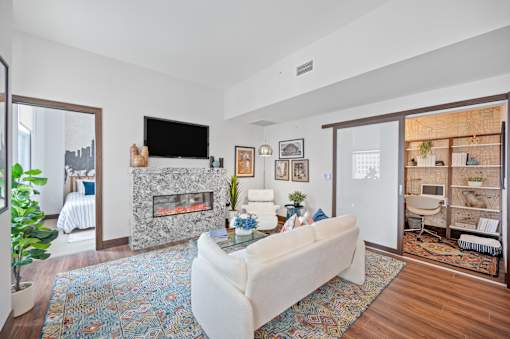 A living room with a fireplace and a white couch at Sky Central Apartments, Cincinnati, 45202