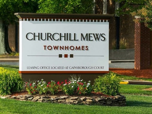 Placard with the Churchill Mews logo near apartments entrance