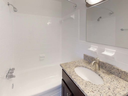 Granite counters in bathroom with sink at Gainsborough Court Apartments, Virginia