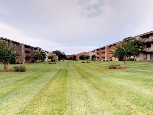 Lawn area with exterior view of apartment complex at Gainsborough Court Apartments, Fairfax
