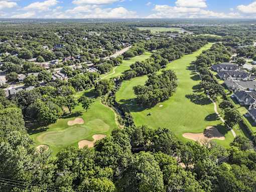 A golf course surrounded by houses.