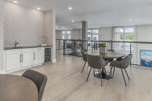 A dining room with a table and chairs.