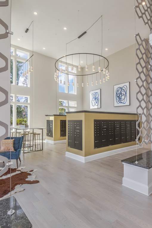 A modern interior with a reception desk and hanging lights.
