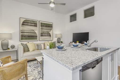 A kitchen with a white counter top and a sink.