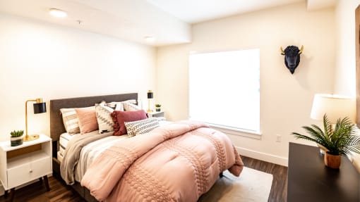 a bedroom with a large bed and a window