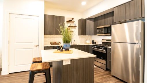 a kitchen with stainless steel appliances and a white counter top