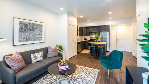 a living room and kitchen with a couch and a table