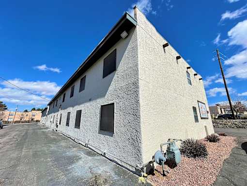 A white building with a blue sky in the background.