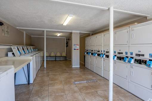 A laundry room with washers and dryers.