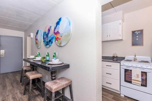 A white kitchen with a stove and a fridge.