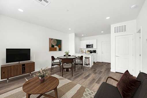 A modern living room with a wooden coffee table and a flat screen TV.